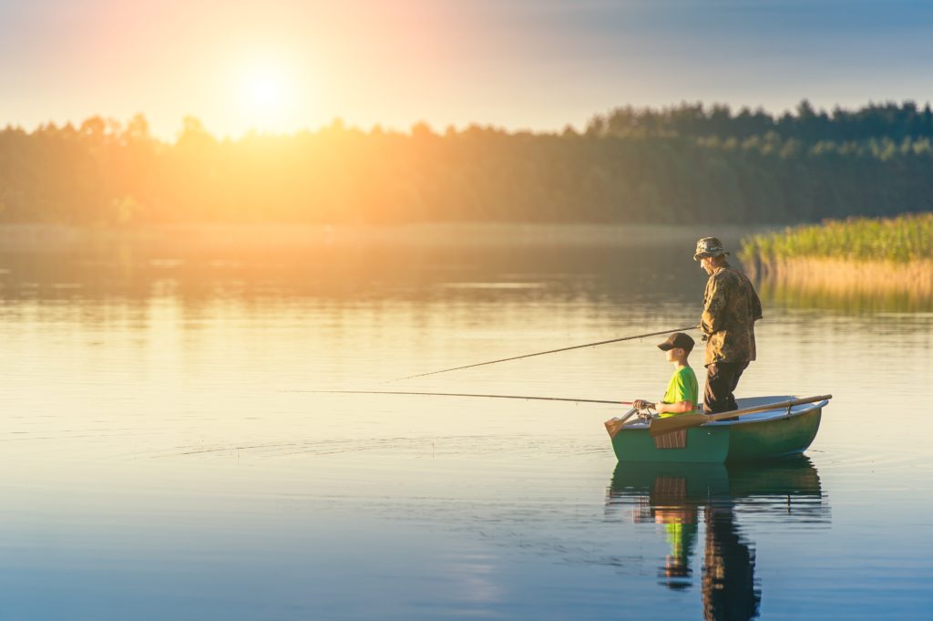 a father and son fishing on a boat at possum kingdom lake